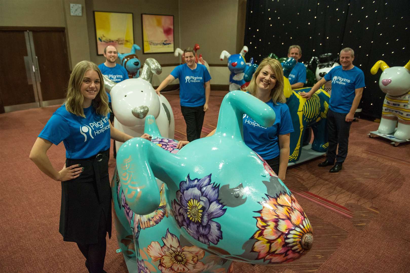 Pilgrims Hospice staff preparing to wheel the Snowdogs into the auction room