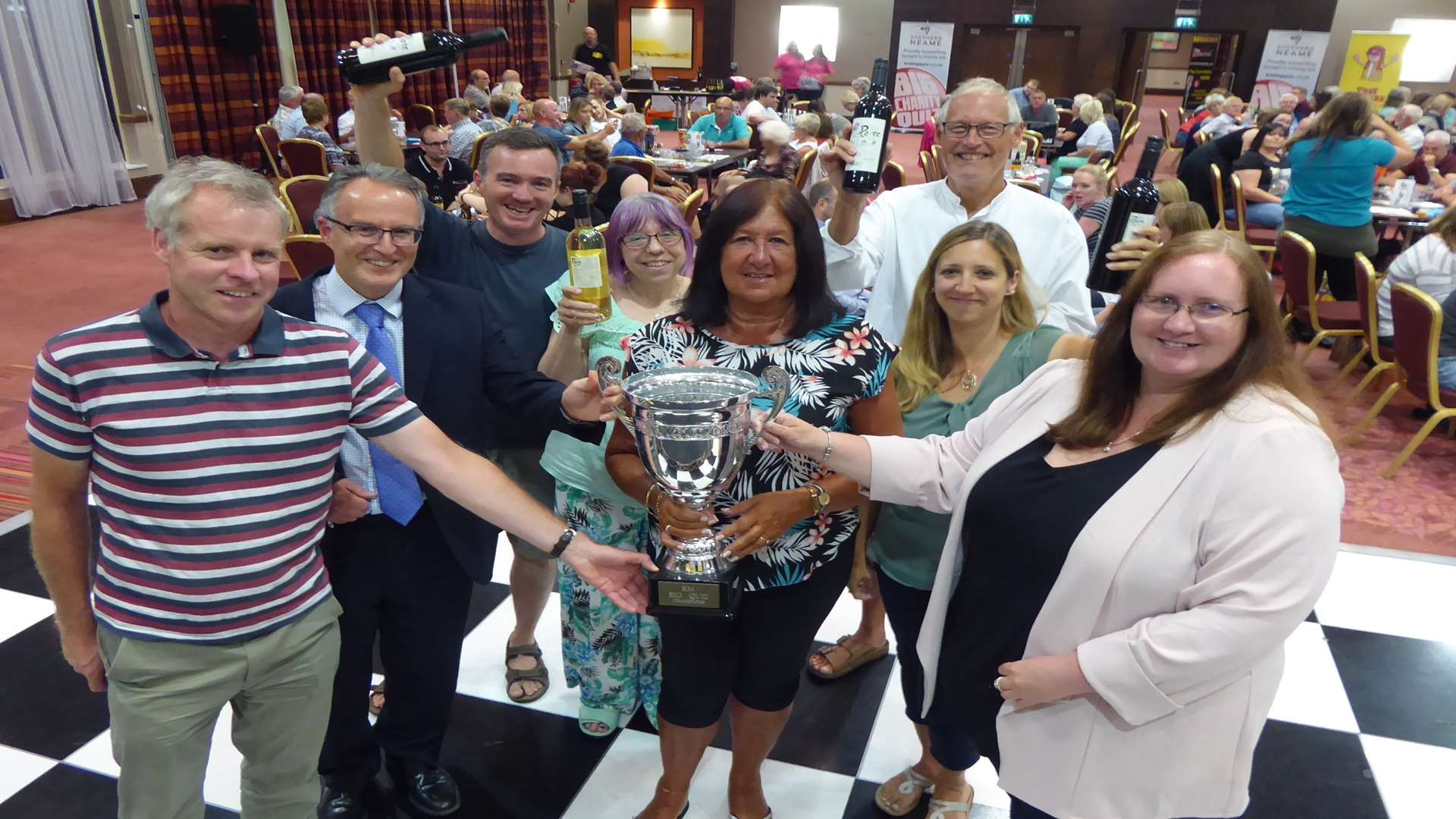 Moomins receive Ashford KM Big Charity Quiz trophy from David Fifield of Hallett and Co, Clive Perry of Specsavers and Rebecca Naylor of Ashford International Hotel.