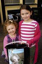 Four-year-old Angel and Emelia, seven, with collection bucket at family music day in Gravesend to raise money for Aaron Lindridge.