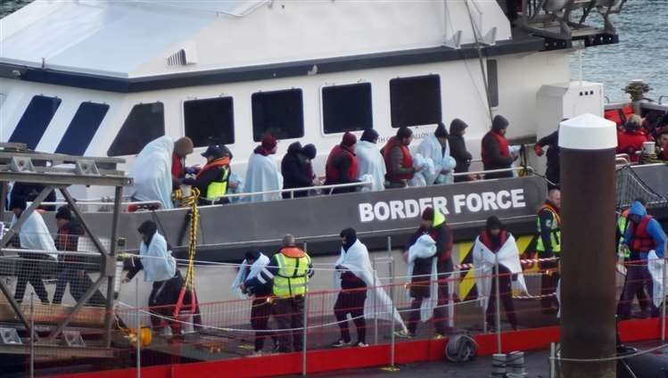 A group of people thought to be asylum seekers are brought into Dover on a Border Force vessel. Picture: Gareth Fuller/PA