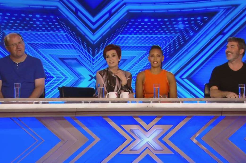 Phil in action on the X Factor judging panel alongside Sharon Osborne, Mel B and Simon Cowell.
