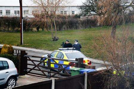 Armed police move on a target in Range Road, Eastchurch