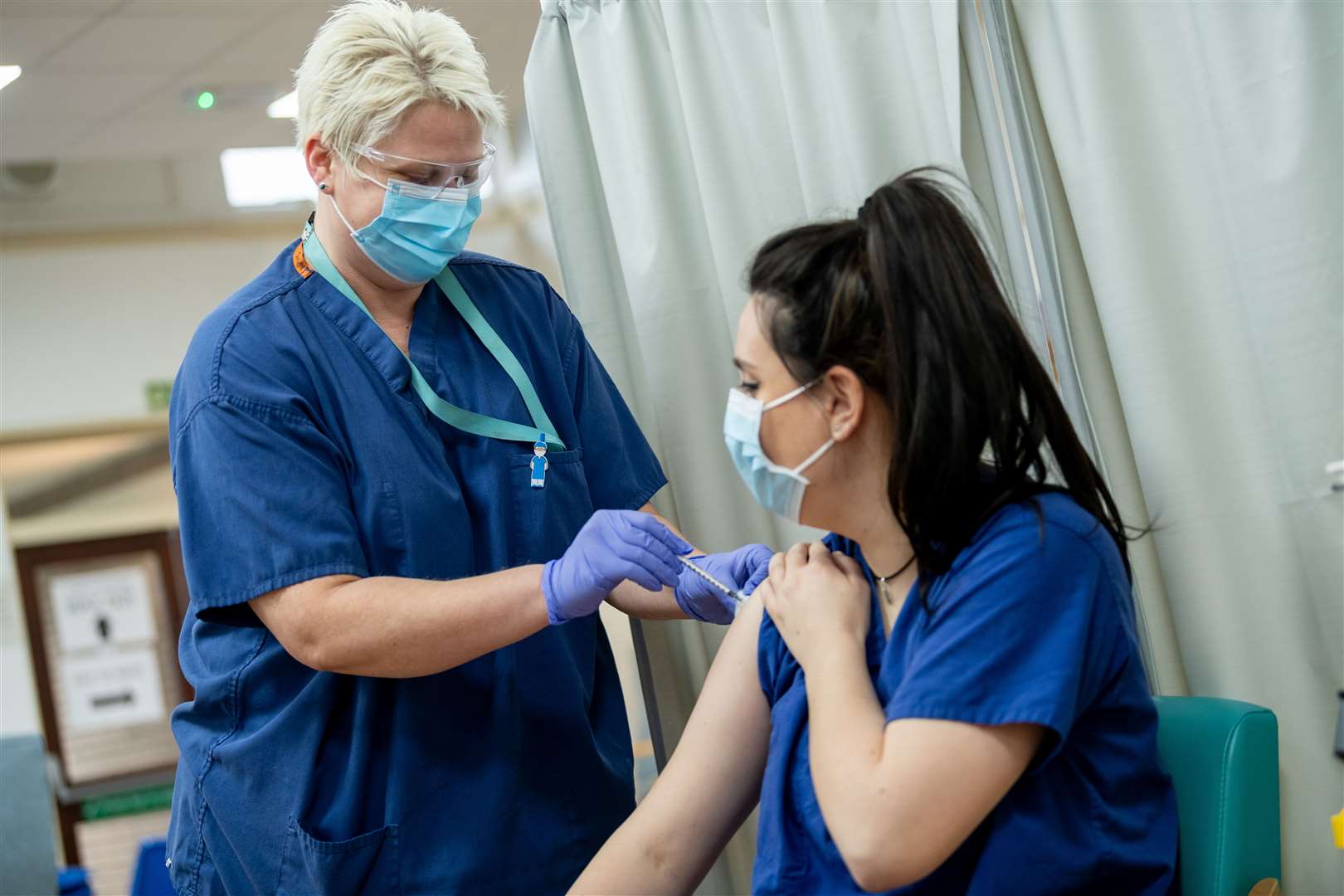A healthcare worker receiving her jab Stock picture