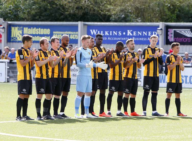 Maidstone players lead the minute's applause for Jason Munn Picture: Andy Jones