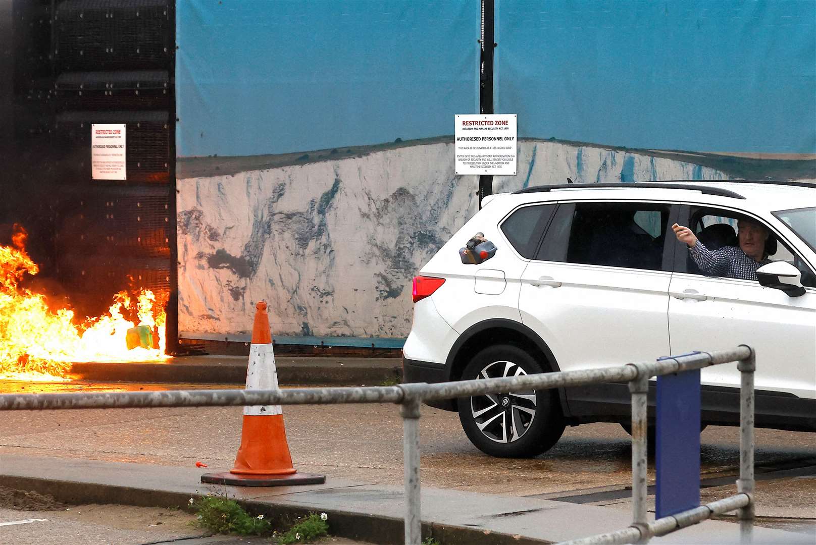 Andrew Leak throws improvised explosives out of his car window in a firebomb attack in Dover. Picture: Reuters/Peter Nicholls