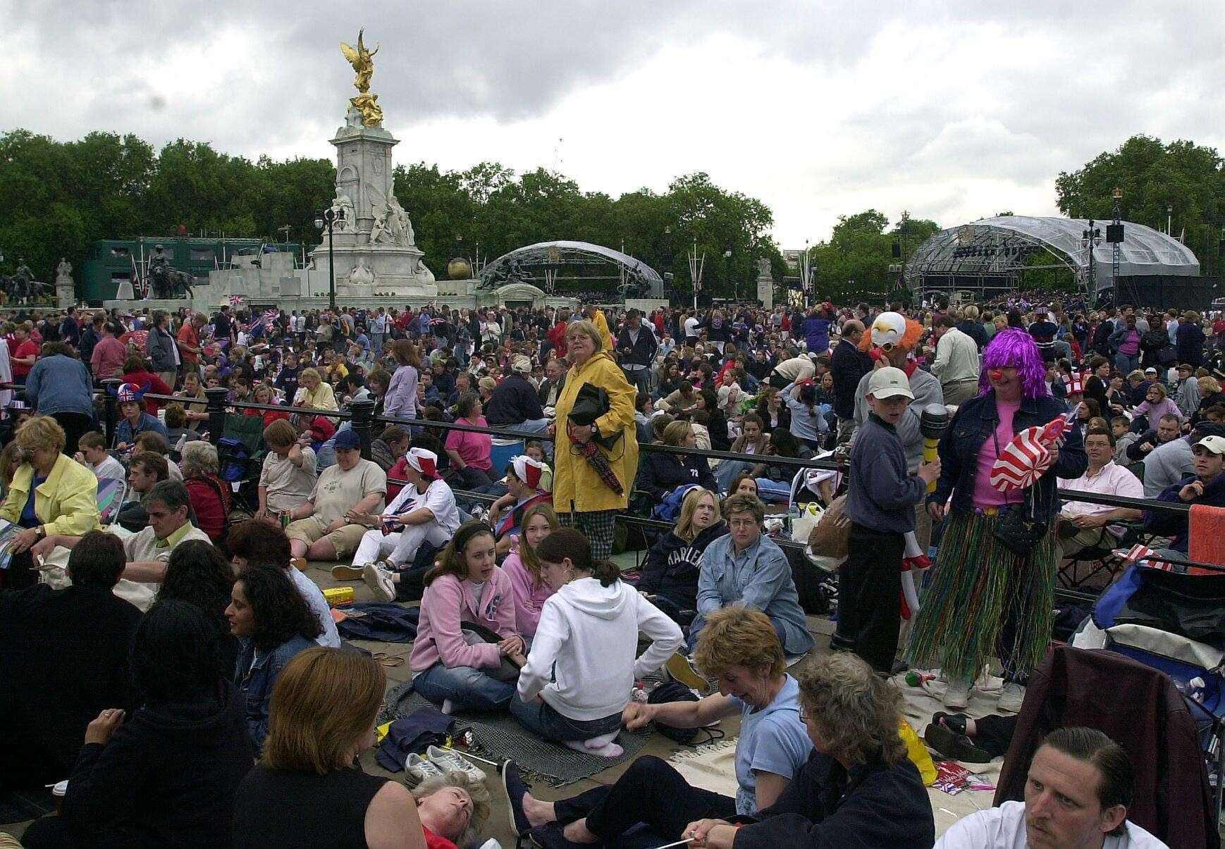 People gather outside Buckingham Palace in 2002 for a concert to celebrate the Golden Jubilee (PA)