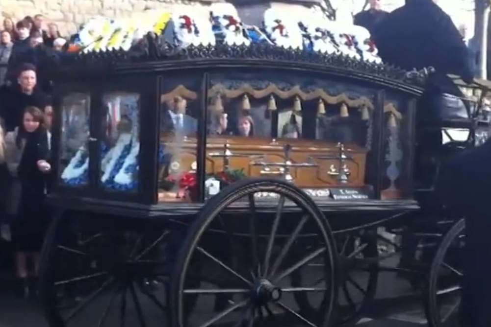 A horse-drawn carriage is used for Felix's coffin