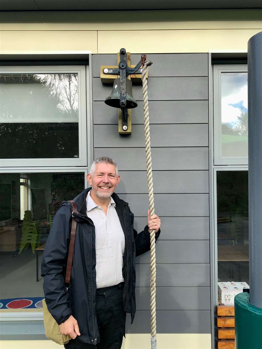 Scott Wishart with the old school bell now re-located to the new Platt Primary School