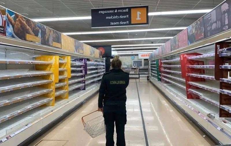 This picture of a paramedic looking at empty shelves in a Sainsbury's store has been circulating online Picture: Facebook (32036583)