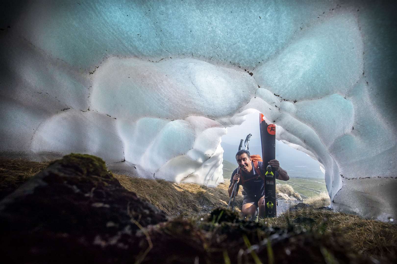 A tunnel has formed underneath one of the remaining snow patches on the slopes of Meall a’Bhuiridh in Glencoe (Jane Barlow/PA)