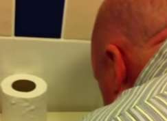 Neil Rix leans over a toilet before snorting a substance