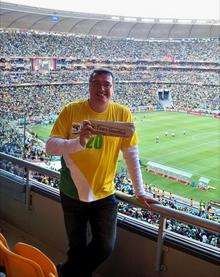 Matt Ramsden with a copy of the Times Guardian inside Soccer City