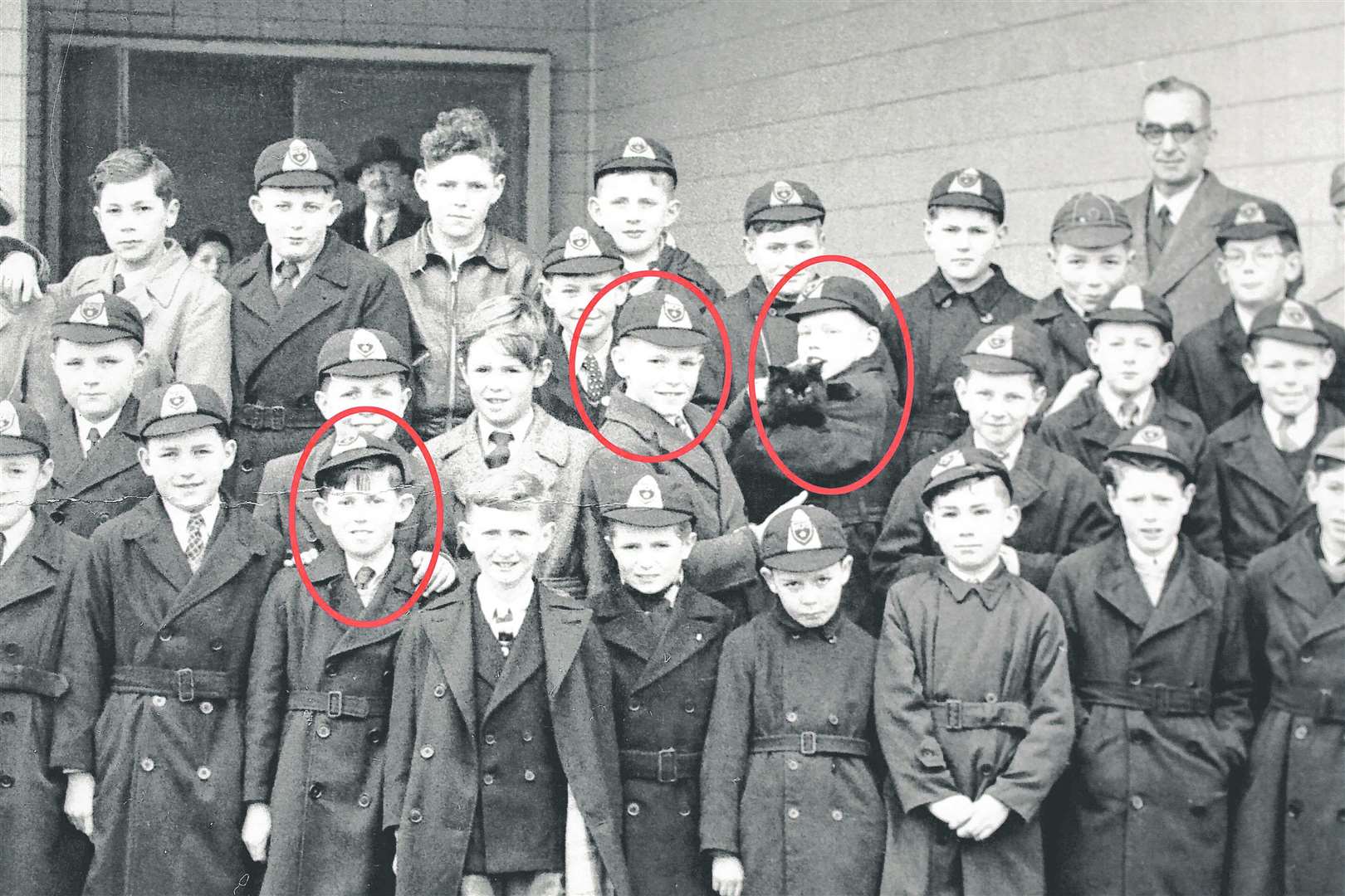 Keith Richards (bottom row 3rd from left), Mick Jagger (right of centre, holding a black cat). Image SWNS