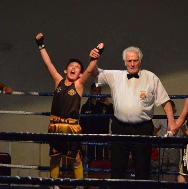 Keen boxer Liam Evans celebrates a win in the ring