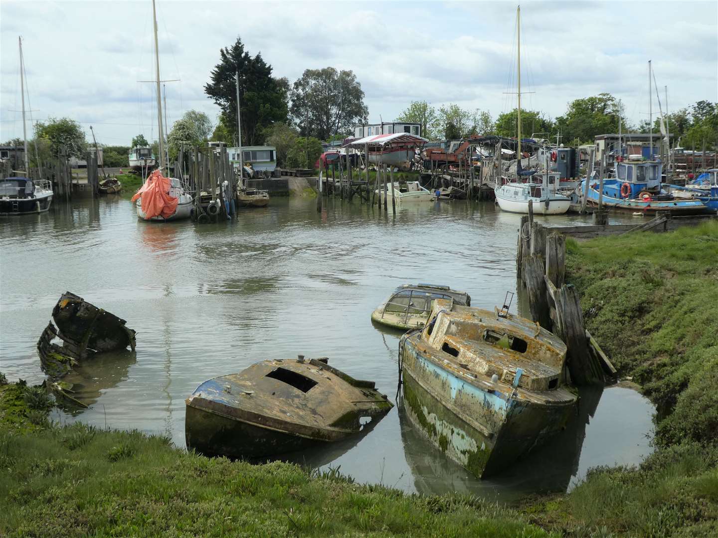 Some ancient vessels at Oare boatyard, slowly sinking into the creek. Pic: Michaela Sharpe