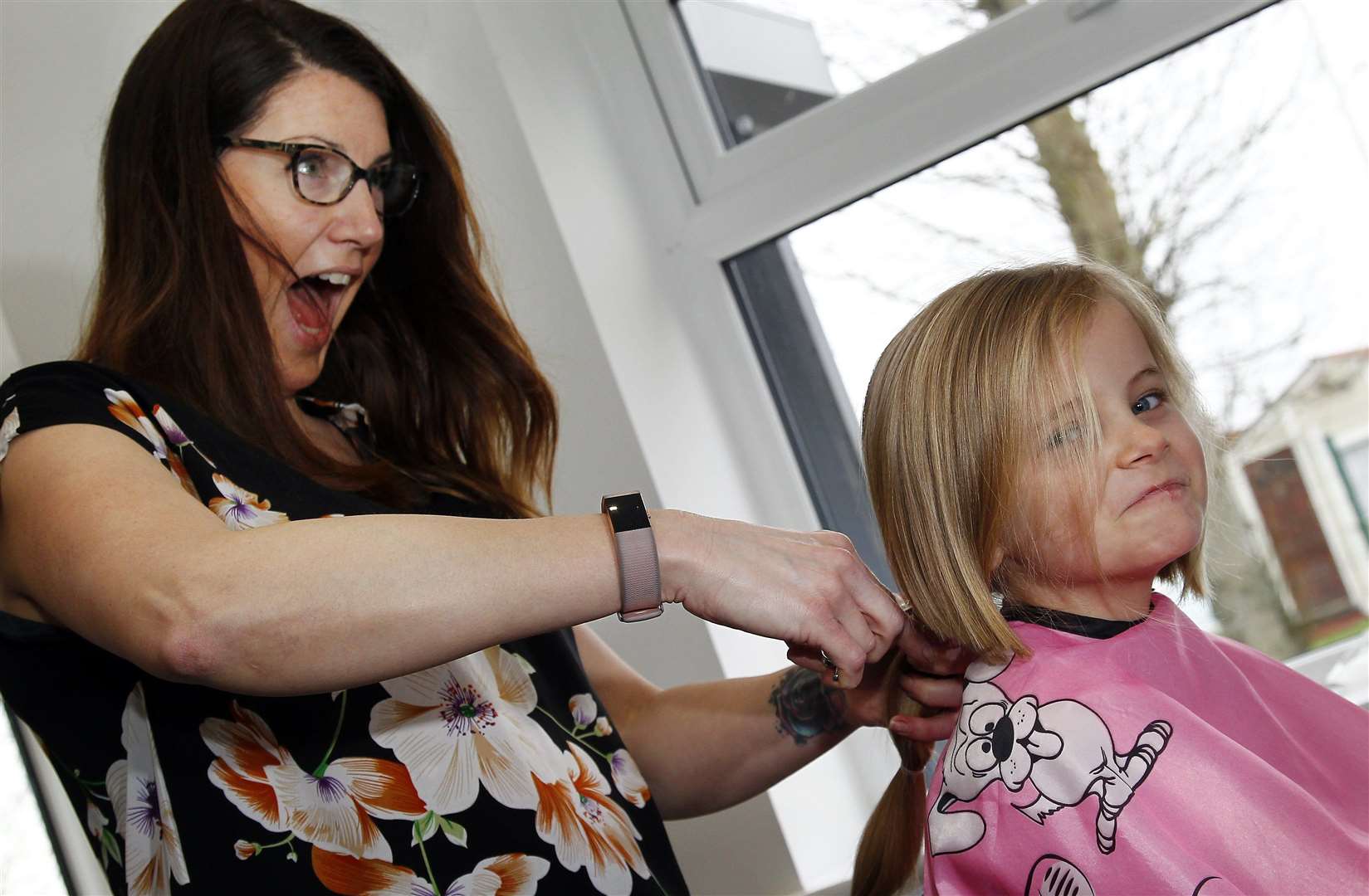 Seven-year-old Tilly has her hair cut for charity by stylist Stacy Thorne at Cut and Glow in Leysdown