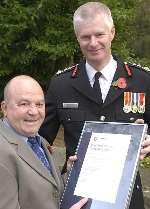 PROUD MOMENT: Chief Fire Officer Peter Coombs presents Eric Lawrence with his certificate. Picture: JOHN WARDLEY