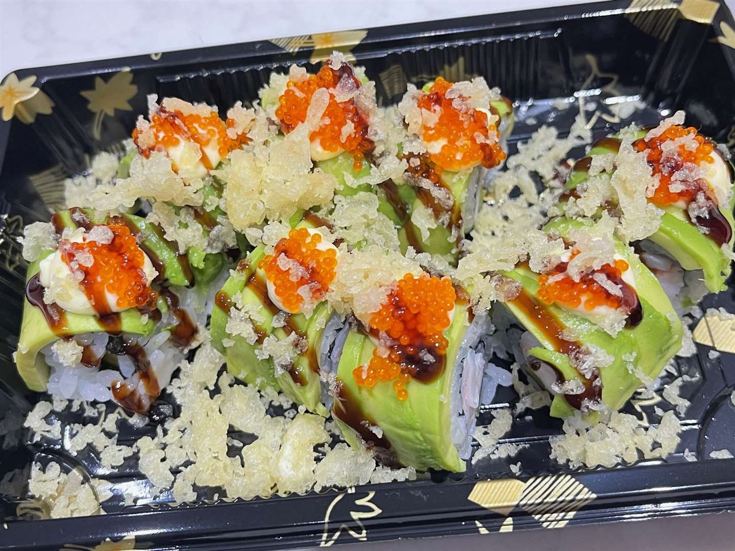 The Dragon Roll made from tempura prawn, tobiko, mango, avocado, sweet soya and mayo. Picture: Sumo Sushi