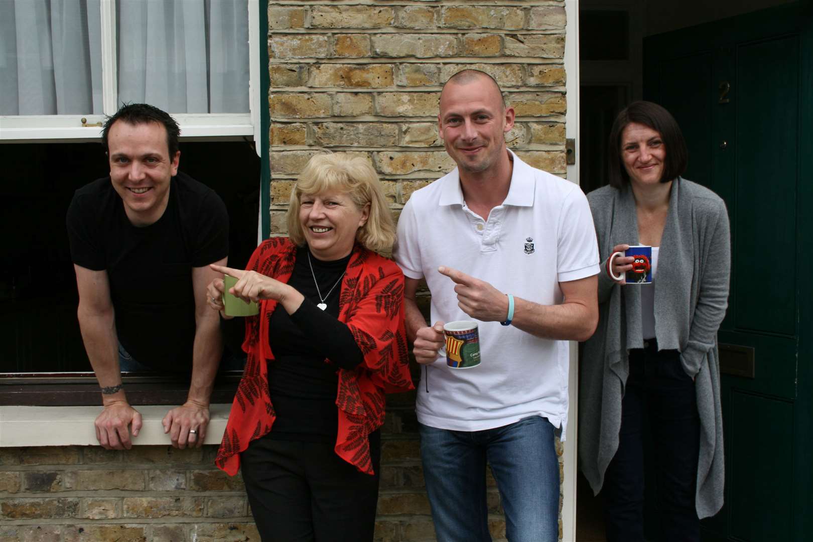 Sipping tea outside their house in St Margarets Street, Rochester, on the torch rout, homeowners Martin and Laura Young with Sheena Conner and Steve Wyborn