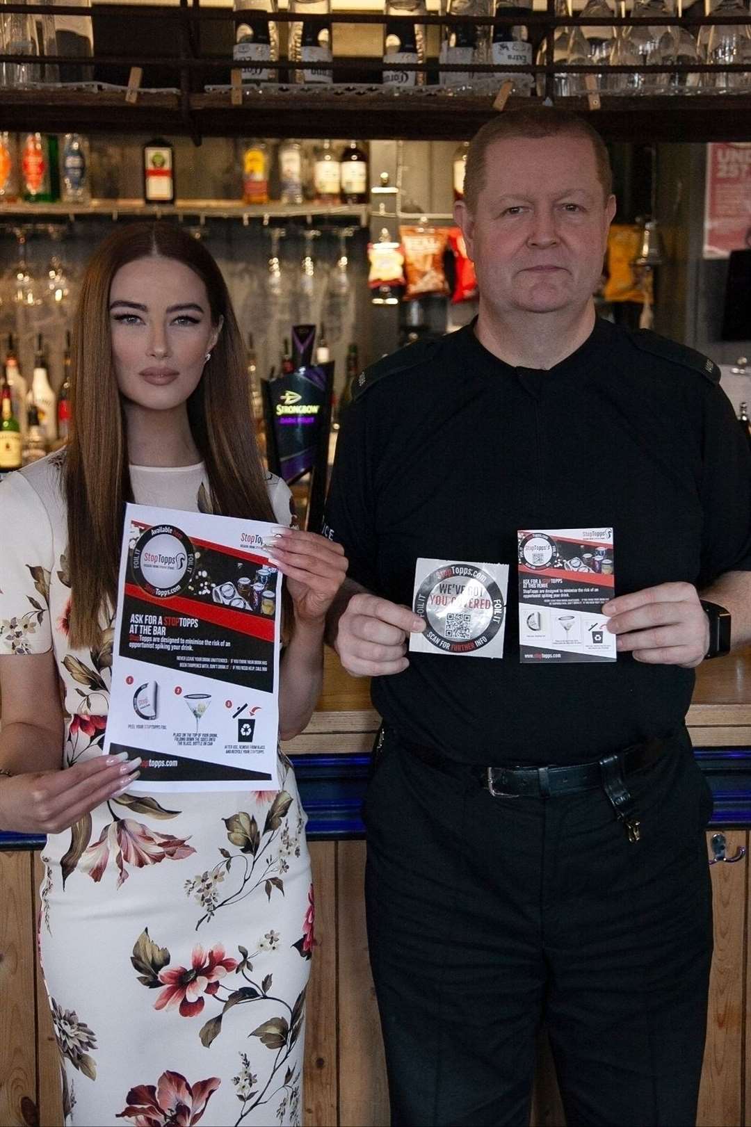 BID director Sarah Jane Adams with Kent Police Licensing officer showing off the Stop Topps covers