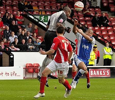 Walsall keeper Clayton Ince comes and heads clear ahead of Simeon Jackson. Picture: Barry Goodwin