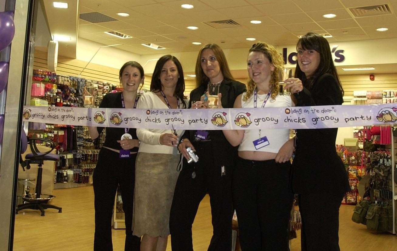 Claire's Accessories staff cut the tape to open their unit. Pic: Matthew Walker