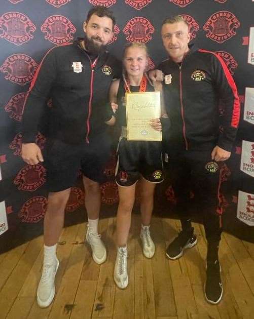 Apex Boxing Academy coaches Lloyd Allibone and Kyle Rayner with Barum Box Cup winner Gracie Taylor