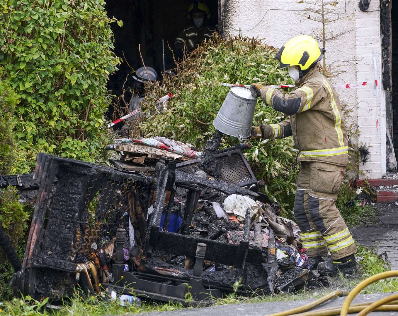 Firefighters worked to clear debris from the incident on Saturday (Steve Parsons/PA)