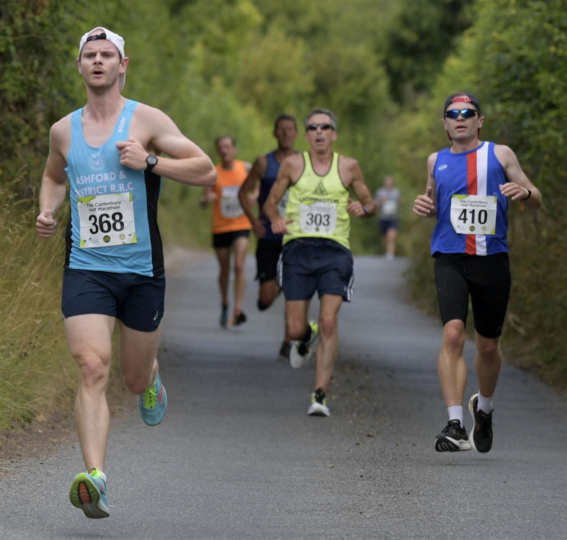 Aiden Gorham (left) on a charge for Ashford & District Road Running Club. Picture: Barry Goodwin