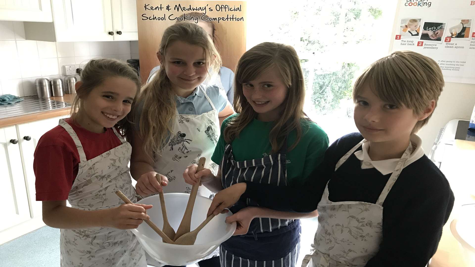 Tallis Pilbeam-Carter, Antonin Corcoran, Summer Graham and Alice Williams, all 10 years old from Petham Primary School, get cooking.