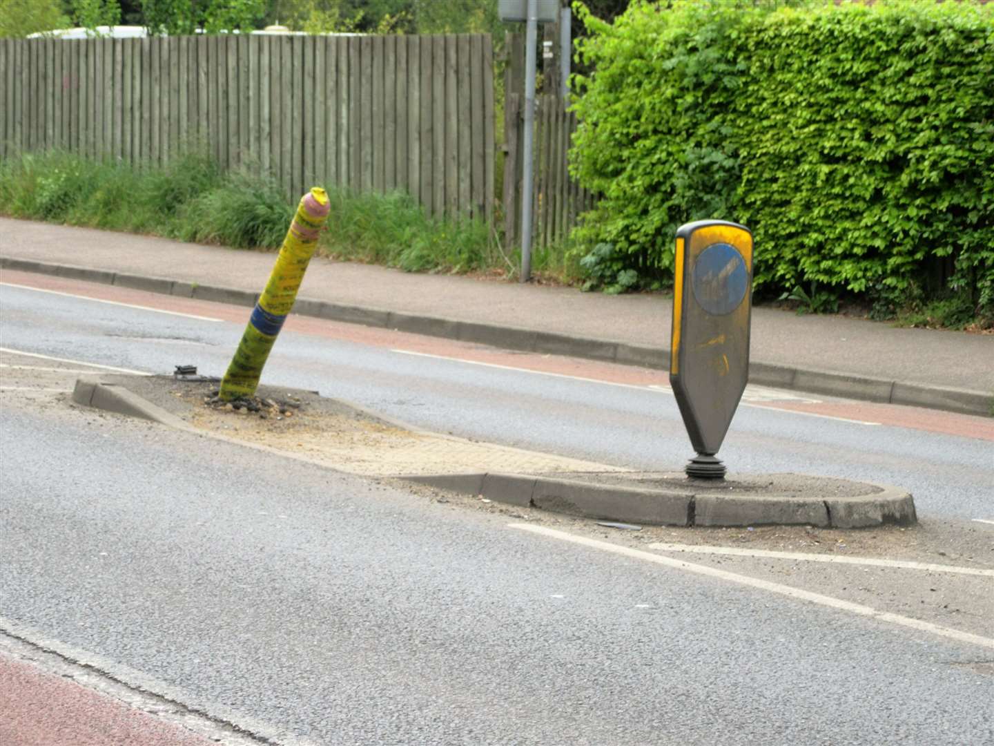 One damaged street lamp following a recent collision and one dirty bollard
