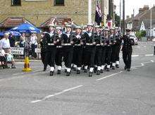 The Fleet Air Arm Association National Standard and Guard march through Eastchurch High Street