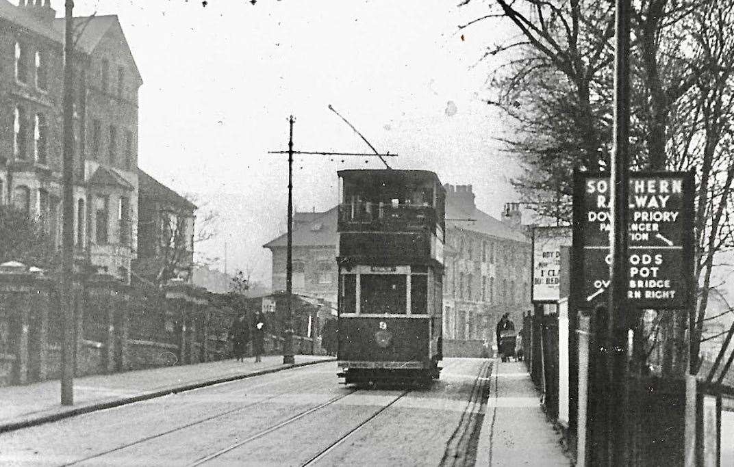 A tram going over the railway bridge at Folkestone Road circa 1920s. Behind it, to the left, is the junction with Clarendon Road and to the right are the signs for Dover Priory Station. Picture: Colin Varrall