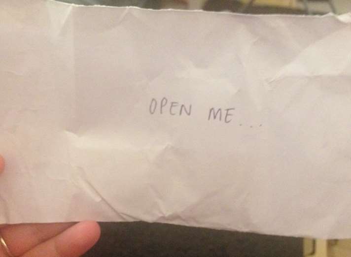 The stranger handed over an envelope with "open me" written on the front
