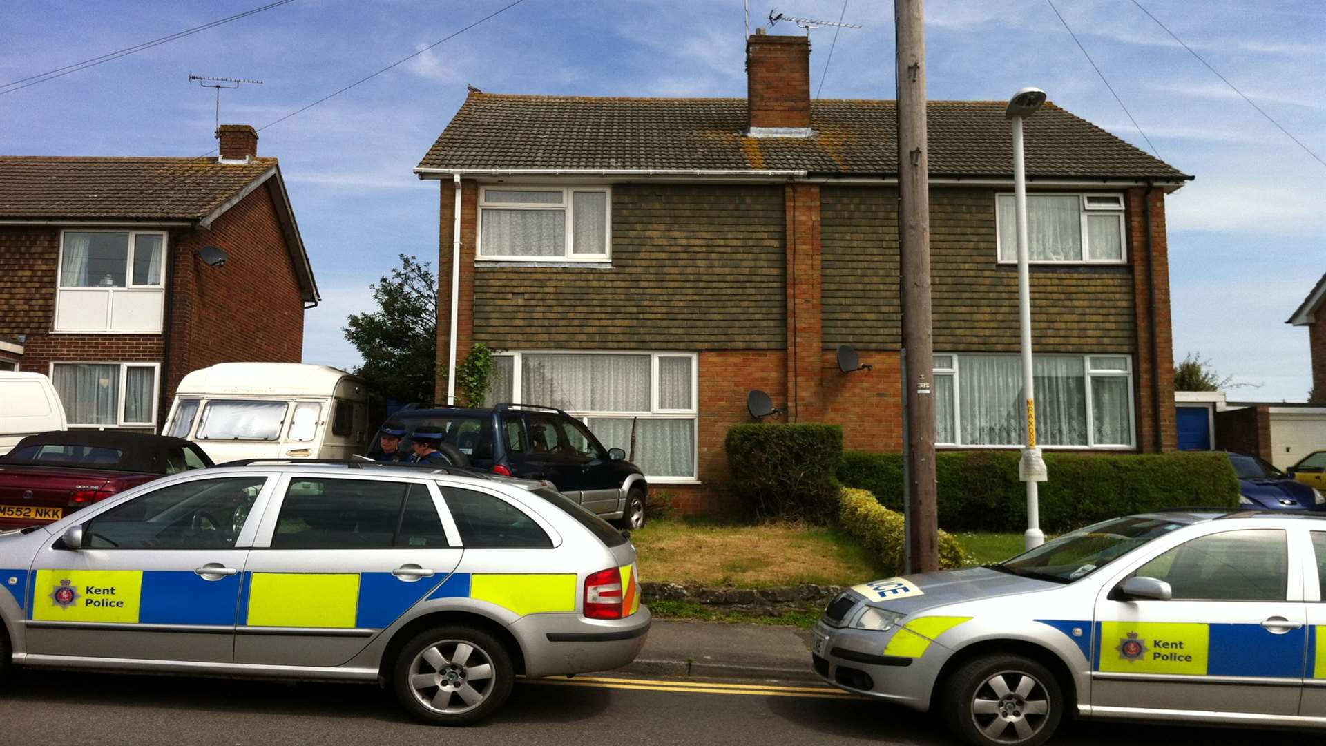 Police outside a house in Ripley Road, Ashford, after a woman's body was found