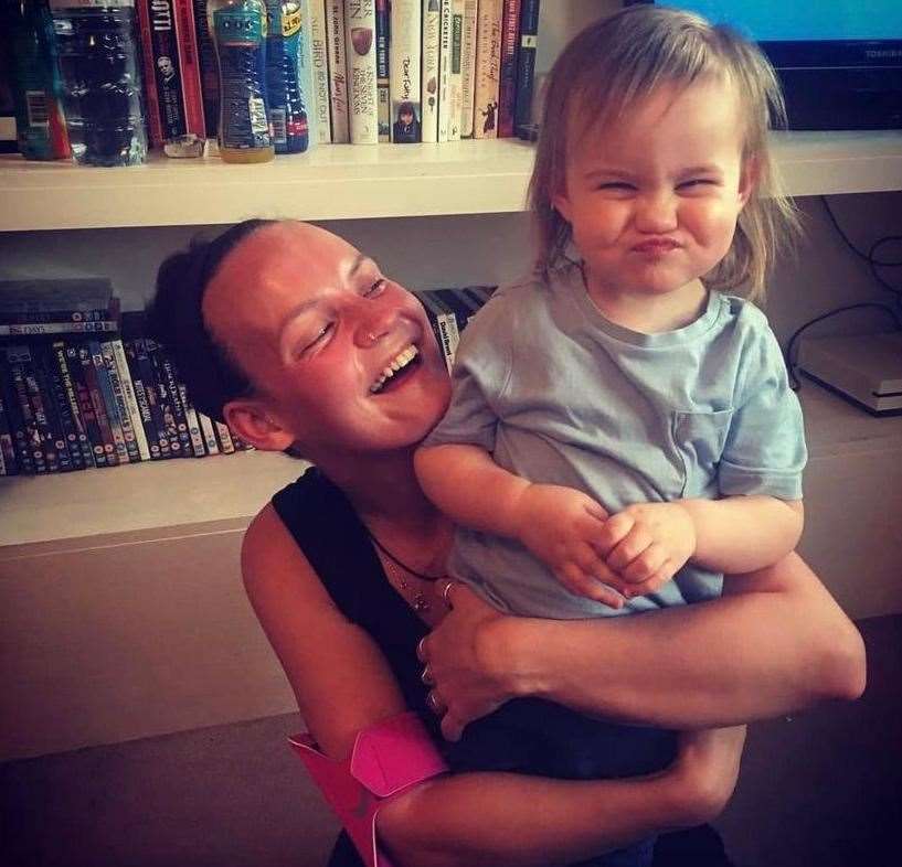 Danielle with daughter Joey as she ran a marathon in her living room during lockdown for cancer charity, CoppaFeel