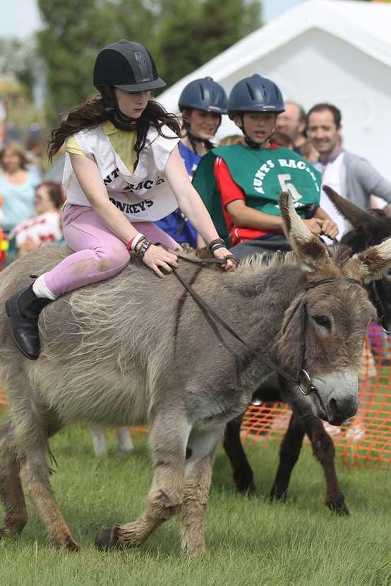 Tirilen Christie, 14, ahead in a donkey race at the Annual Donkey Derby