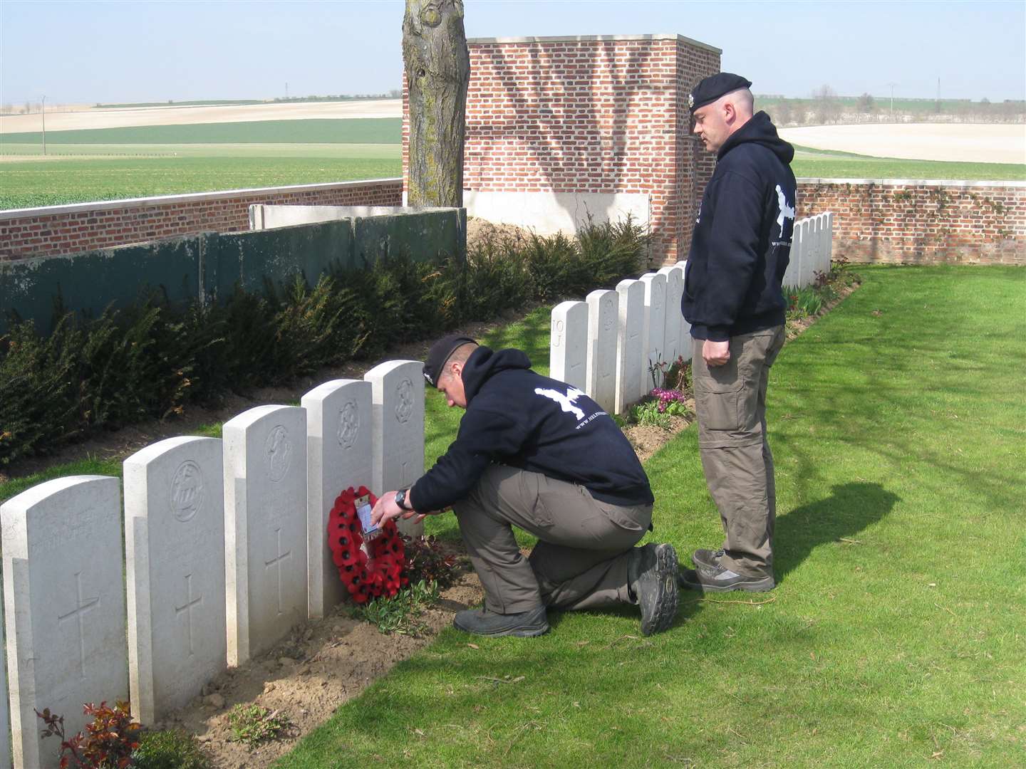 Sgt Harris's relative Anthony Pearson lays a wreath on his grave at the Derancourt Communal Cemetery near Albert in France
