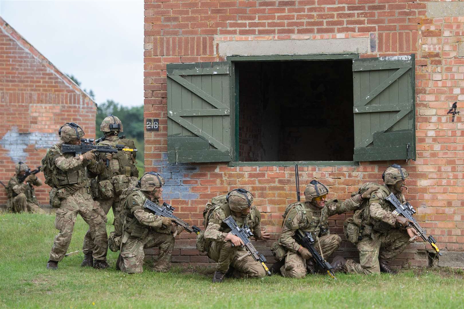 Officer cadets launch a platoon attack on a compound at the Stanta training ground near Thetford, Norfolk, as part of a training exercise (Joe Giddens/ PA)