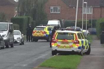 Cade Road in South Ashford was cordoned off by armed police