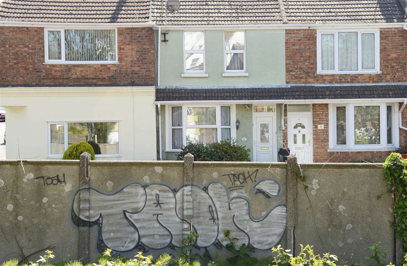 Graffiti on walls in front of homes in Dudley Road