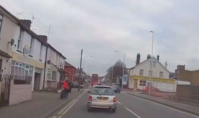 The biker mounts the pavement and narrowly misses a pedestrian in Jeffery Street, Gillingham