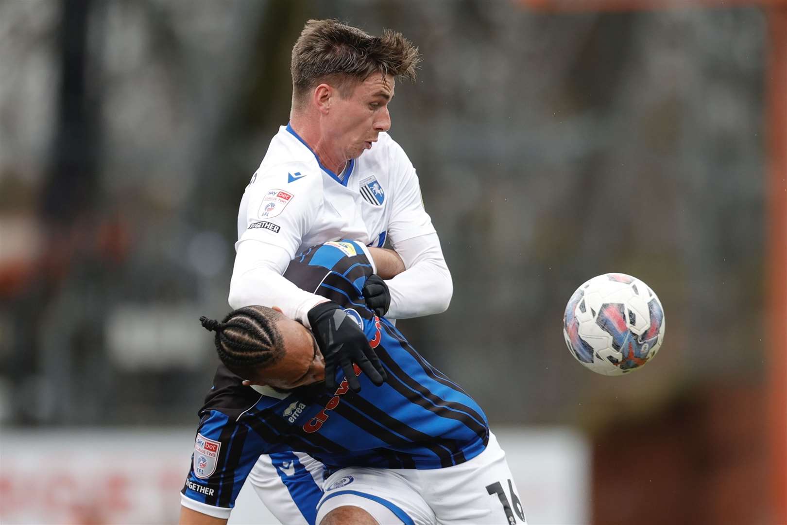 Oli Hawkins challenges Rhys Bennett for the ball in the League 2 match at Rochdale