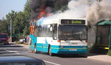Flames engulf the rear of the bus. Picture: HARRY PUREWAL