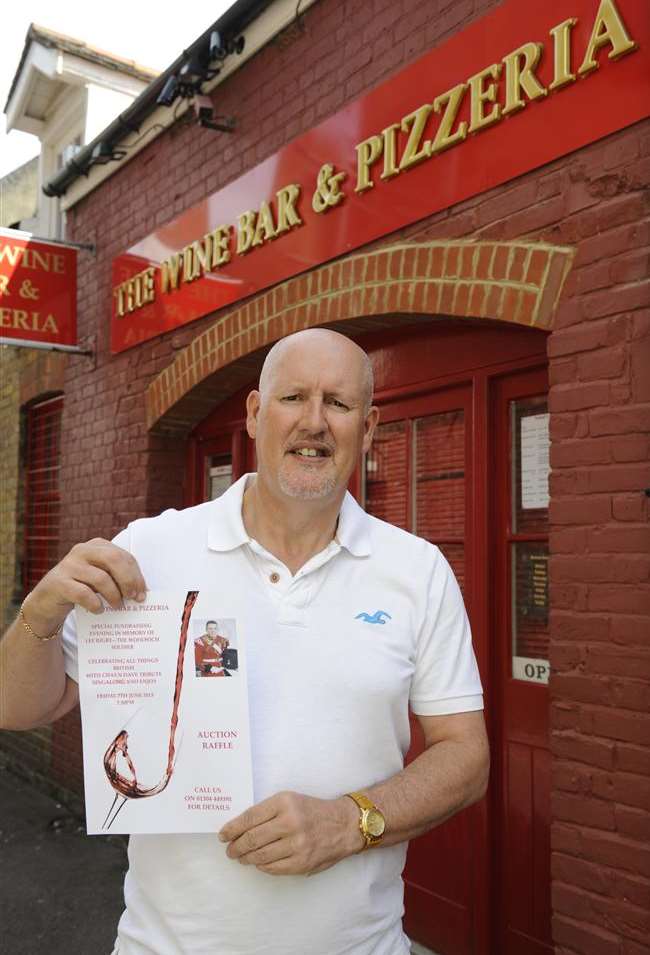 Fundraising night organiser Phillip Moore with the poster outside the Wine Bar and Pizzeria