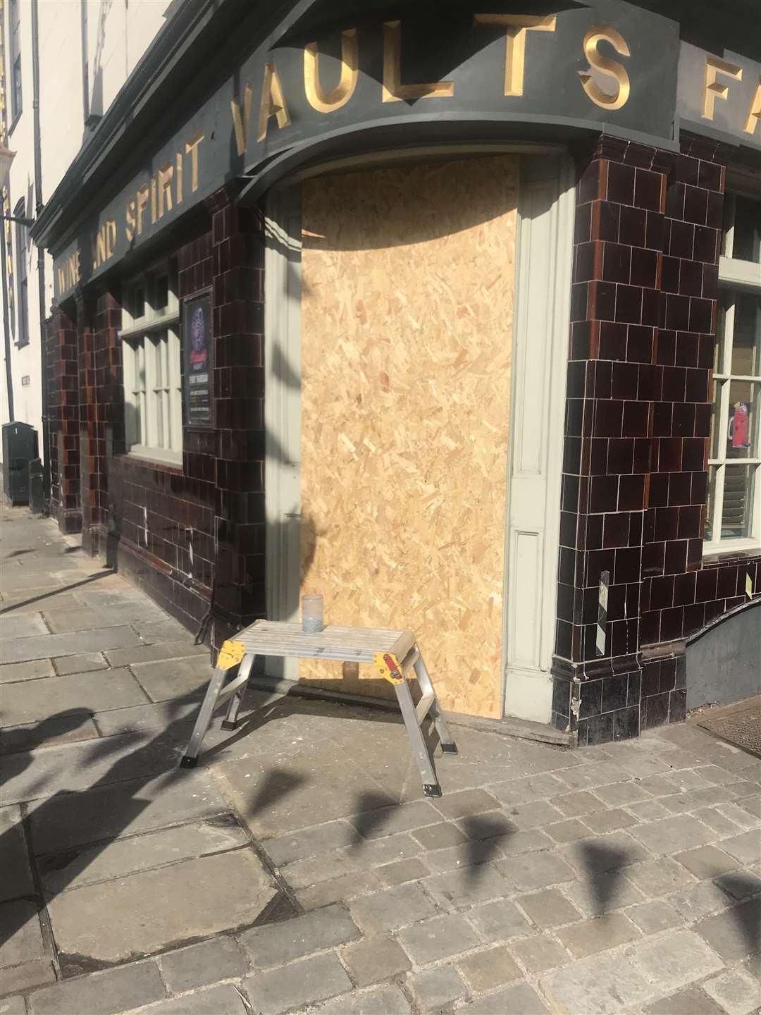 Boarded up pub door after raid which saw a man arrested on suspicion of drug dealing