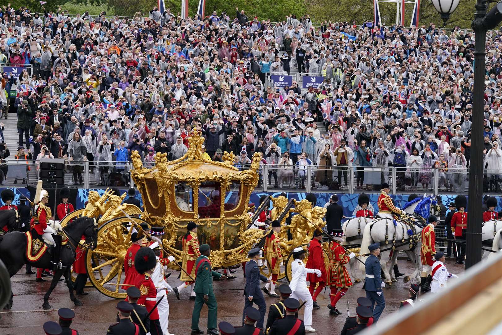 Charles and Camilla are carried in the Gold State Coach, pulled by eight Windsor Greys, as they return along The Mall to Buckingham Palace (Niall Carson/PA)