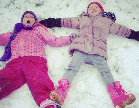 Isla Healy, four, and Izzy Hunt, also four, from Iwade, making snow angels.