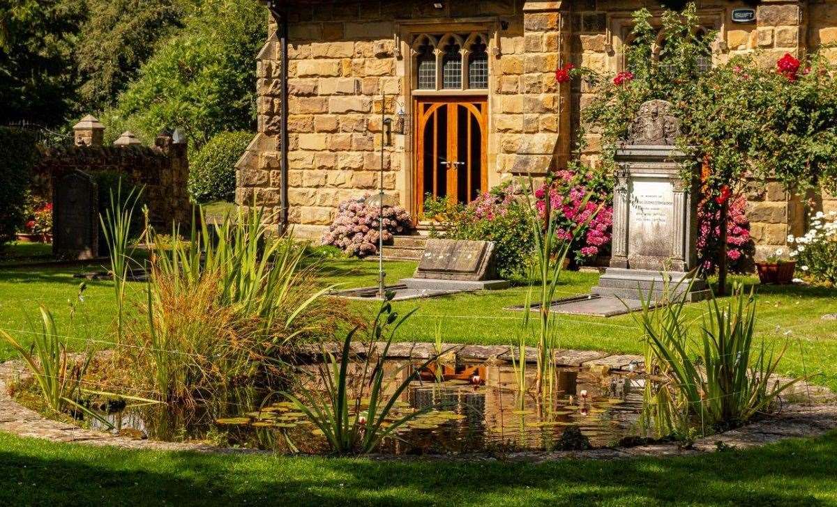 There's a pond and colourful flowers outside the sandstone chapel. Picture: Graham John
