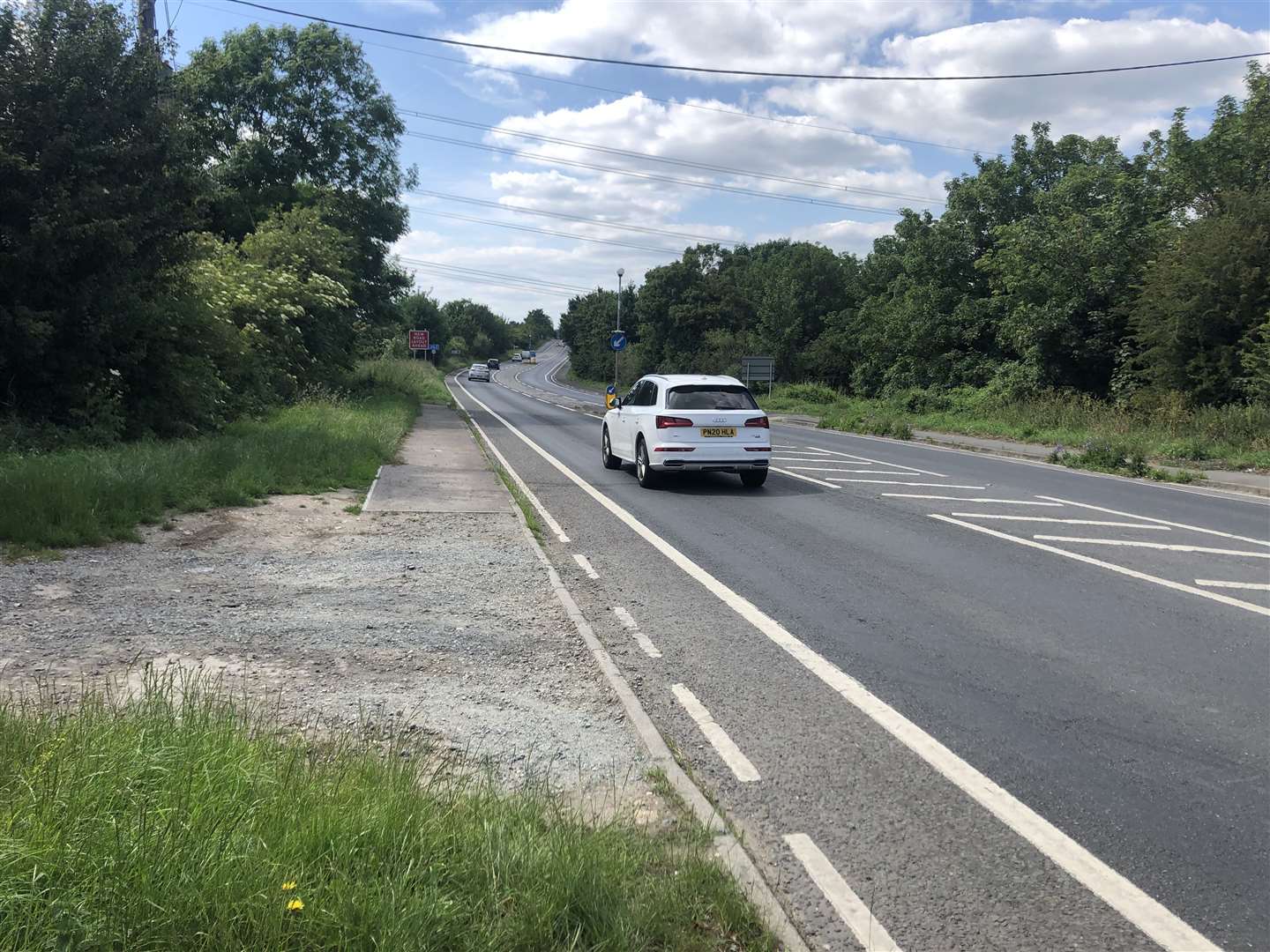 One of the south side bus stops where passengers get off on a grass verge